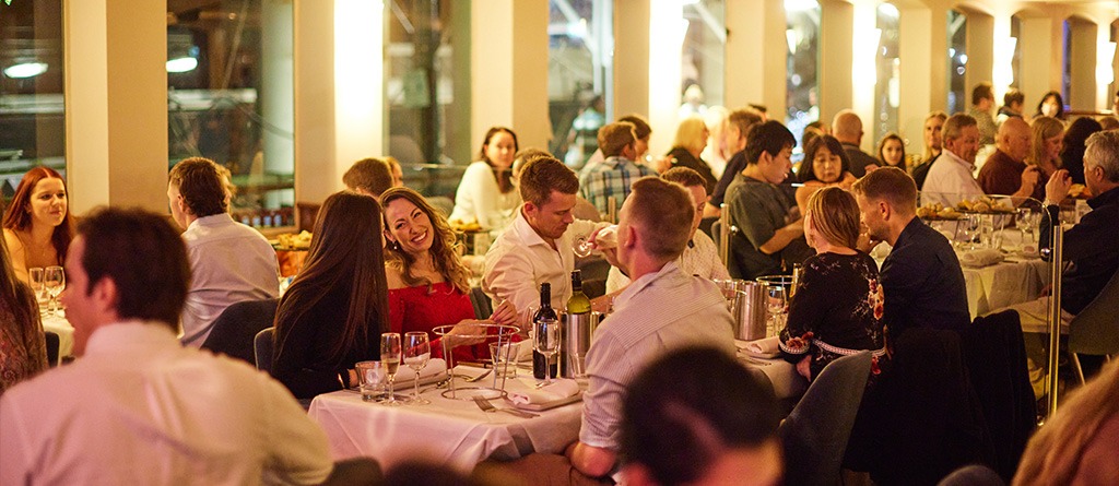 Couples and groups dining onboard with Sydney Harbour skyline views