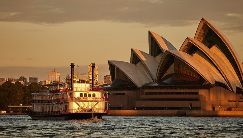 Luxury Sydney dinner cruise sailing past the Opera House at sunset